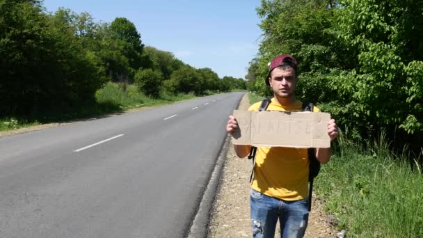 Tourist in a yellow T-shirt with a sign is upset — Stock Video