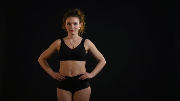 Portrait of beautiful young woman on black background — Stock Video