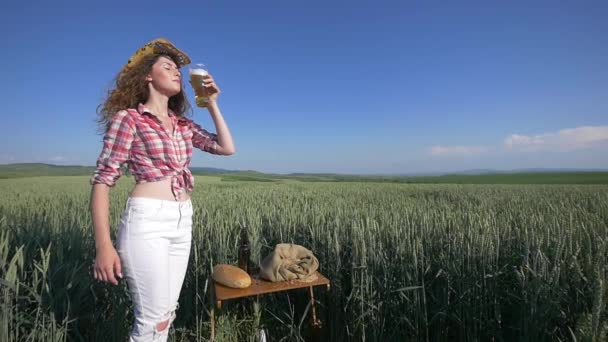 Dívka s pivem na obiloviny field v létě — Stock video