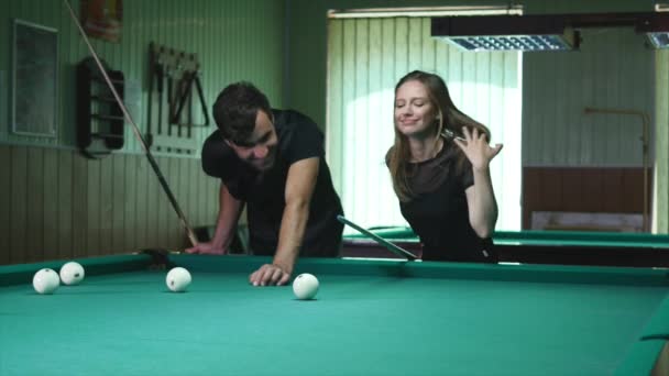 Man Showing His Girl Where To Hit The Ball - Young Woman Receiving Advice On Shooting Pool Ball While Playing Billiards — Stock Video