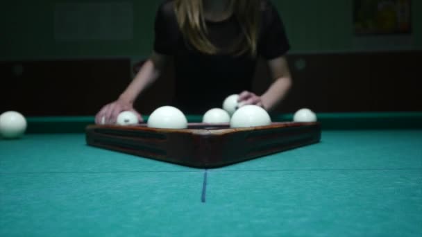 The girl preparing balls for play. Girl sets billiard balls and removes plastic triangle. Billiard balls in starting position. Tracking shot, close up — Stock Video