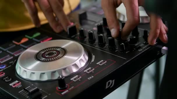 DJ mixes songs on equipment, hands closeup — Stock Video