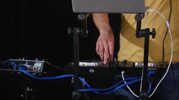 DJ mixes songs on equipment, hands closeup — Stock Video
