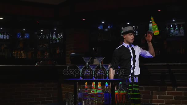 Acrobatic show performed by barman juggling two bottles. bar background. slow motion — Stock Video