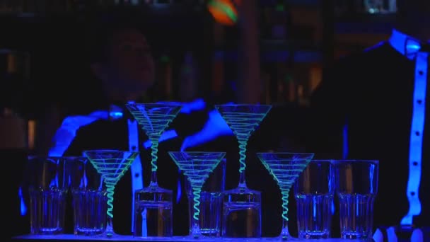 Бармен шоу. Два бармена жонглируют бутылками и Бикер для смешивания. close up — стоковое видео