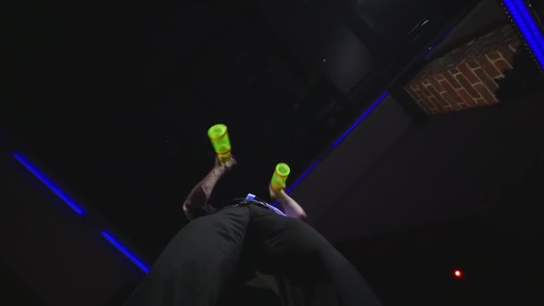 Acrobatic show performed by barman juggling three bottles. bottom view — Stock Video