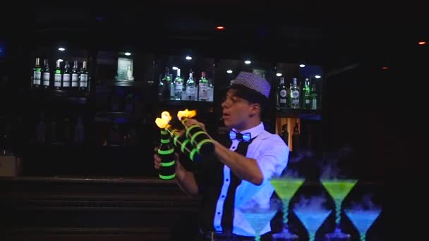 Male bartender juggling bottle with fire. Barman show, clear shots, man professional bartender — Stock Video