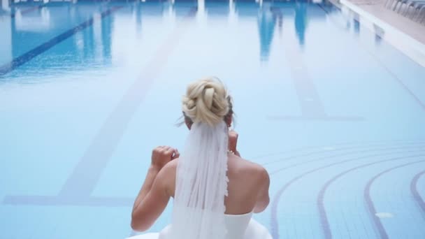 Schöne Braut in der Nähe des Luxus-Pools am Hochzeitstag — Stockvideo