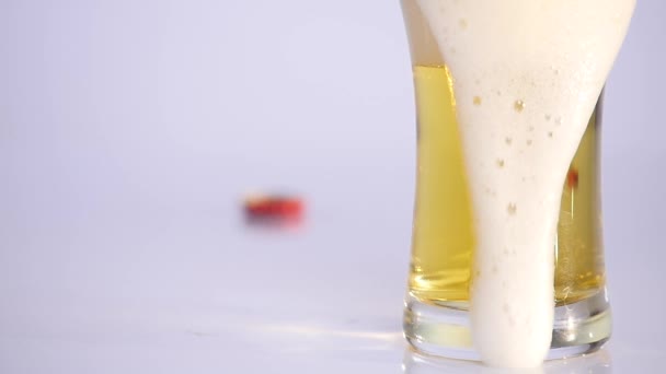 Glass of beer emptying on white background. close up — Stock Video