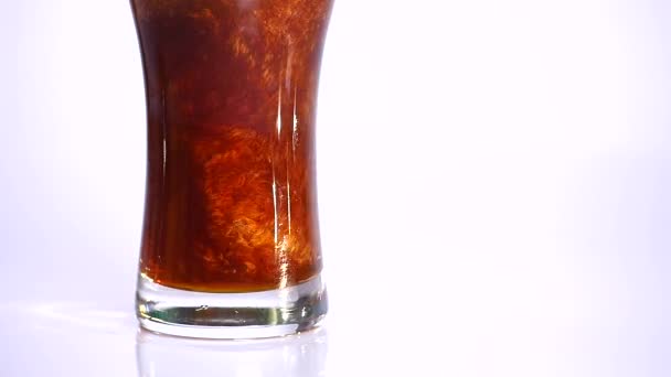 Dark Beer is pouring into glass on white background. close up — Stock Video