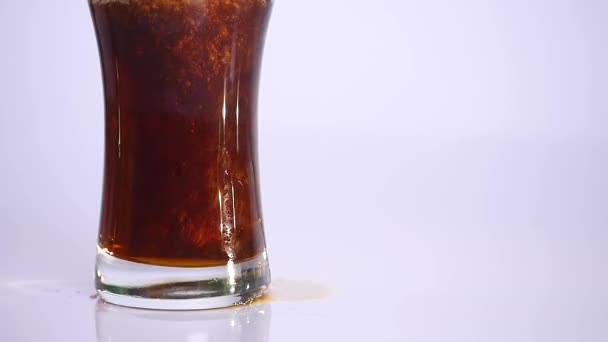 Dark Beer is pouring into glass on white background. close up — Stock Video
