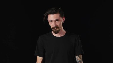 Sakallı genç adam kamera ve Corrects, bang arıyor