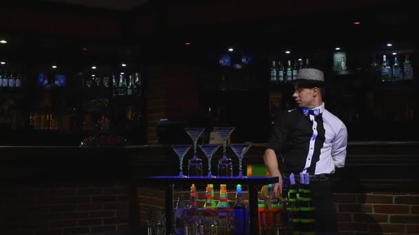 Acrobatic show performed by barman juggling two bottles. bar background. slow motion — Stock Video