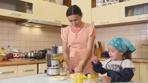 Mother and daughter baking together at home in the kitchen — Stock Video