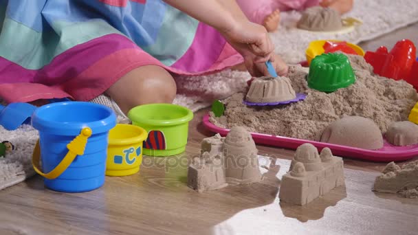 Hand cute little blonde girl playing sand in a studio. close up — Stock Video