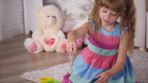 Cute little blonde girl playing sand in a studio. slow motion — Stock Video