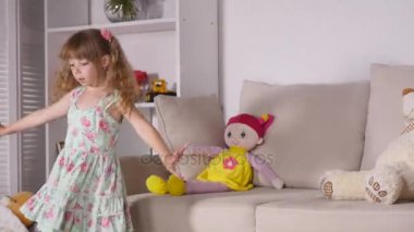 Kapalı bir güneşli beyaz Oda evde ya da anaokulu dans eğleniyor elbiseli mutlu sarışın kız