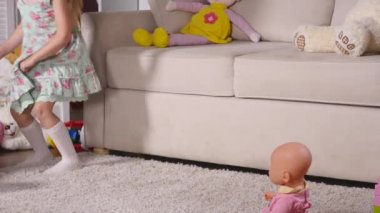 Kapalı bir güneşli beyaz Oda evde ya da anaokulu dans eğleniyor elbiseli mutlu sarışın kız