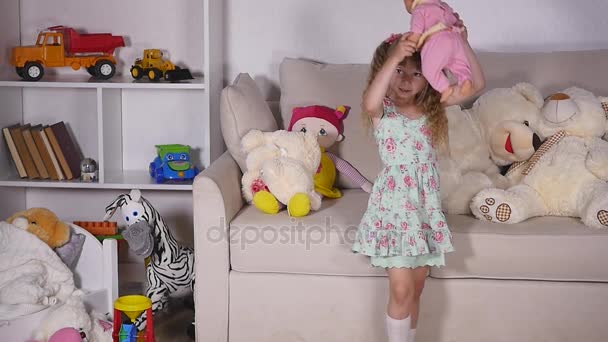 Baby girl playing with doll — Stock Video