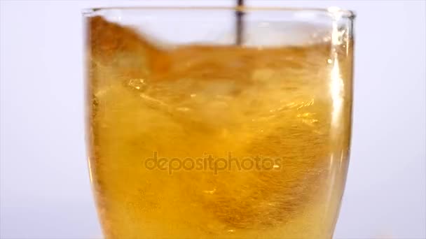 Glass of beer emptying on white background. close up — Stock Video