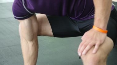 Spor salonunda, o halter kaldırma ve onun pazı çalışma kollarını çalışan adam