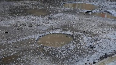Bir su birikintisi, yavaş hareket ile çukura yağmur damlar