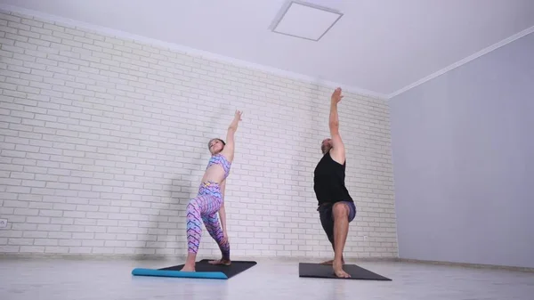 Couple doing yoga together in the studio — Stock Photo, Image