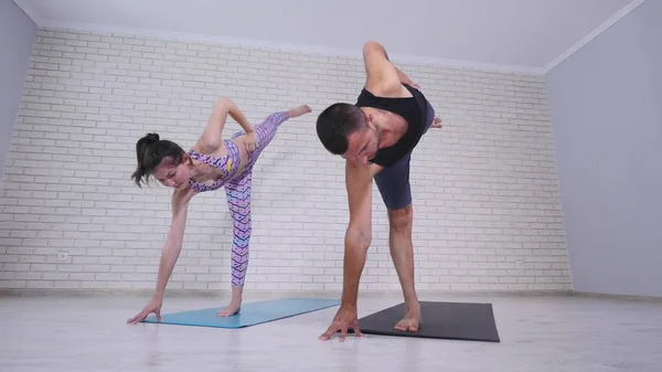 Couple doing yoga together in the studio