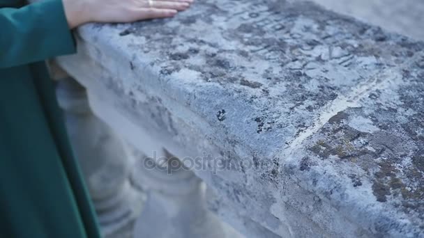 Hand girl on a stone railing — Stock Video