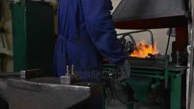 Smith kömürlerin ateşe dönüşür.