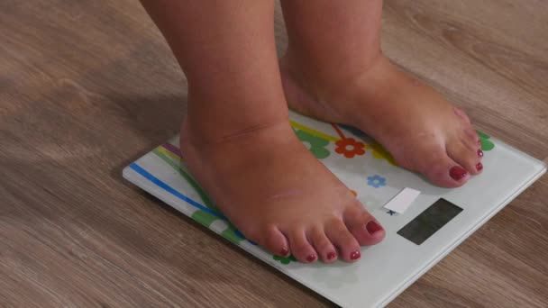 Close-up woman legs approaching to weighing digital instrument and standing on the skale — Stock Video