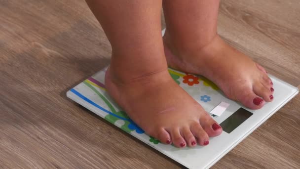 Close-up woman legs approaching to weighing digital instrument and standing on the skale — Stock Video