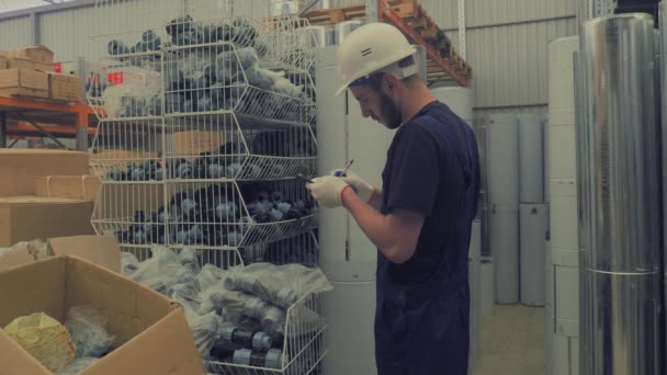 De verkoper in de winkel bouw inschrijven de goederen — Stockvideo