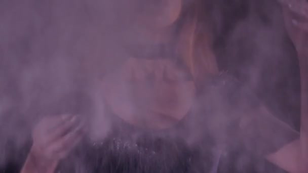 Young woman in a pink empty cloud of flour in a desert grunge factory background — Stock Video