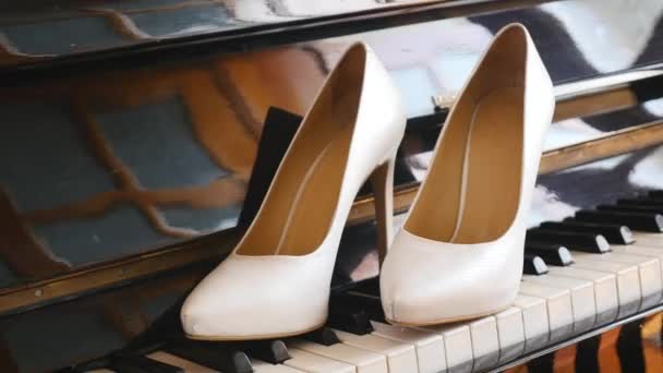 Zapatos de boda nupciales en el piano — Vídeos de Stock