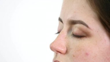 Genç profesyonel kadın photomodel çehresini Güzellik Salonu Makyaj süreci sırasında kapatın. Genç visagiste özel fırça kullanarak göz kapağı üzerinde göz farı uyguluyor