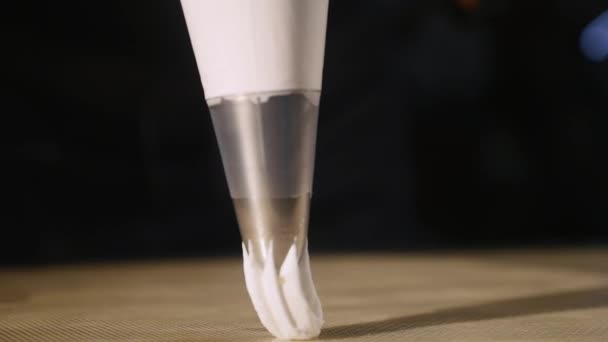 Кондитер из шприца, чтобы протолкнуть массу в кастрюлю для зефира. close up — стоковое видео