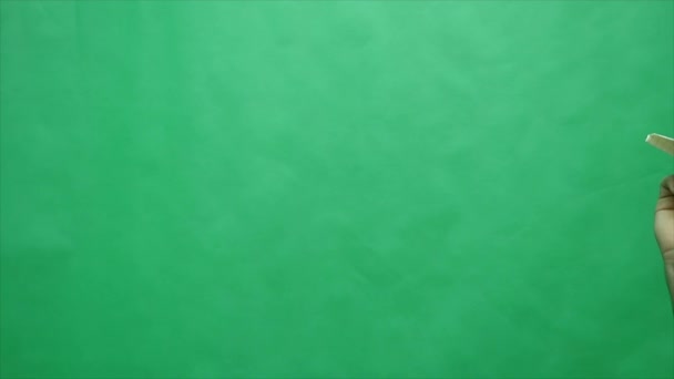 Бумажный самолет на зеленом фоне — стоковое видео
