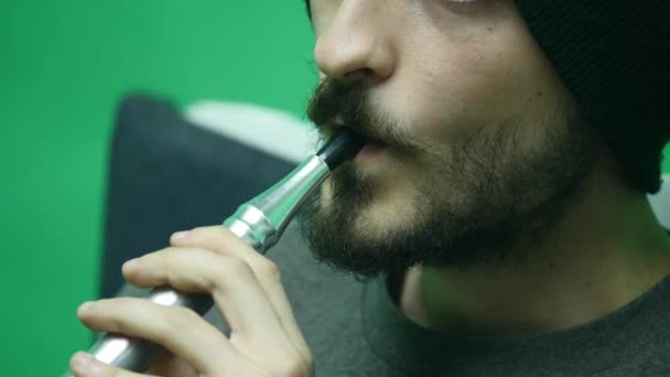 Молодой человек курит кальян в одиночку. close up — стоковое видео