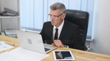 yaşlı işadamı modern ofis içinde bilgisayar ile çalışma