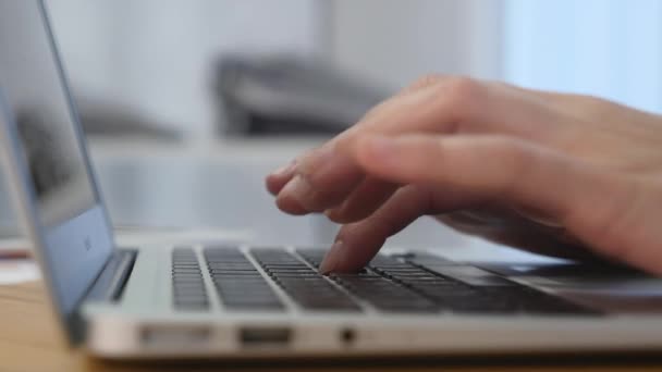 Primer plano de una joven escribiendo en un teclado portátil — Vídeos de Stock