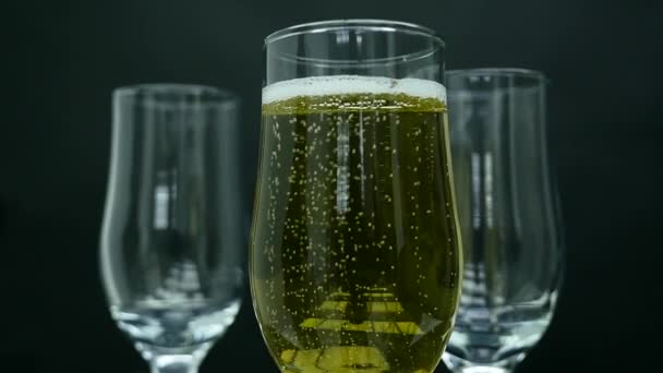 Copos de champanhe com bolhas isoladas sobre fundo preto — Vídeo de Stock