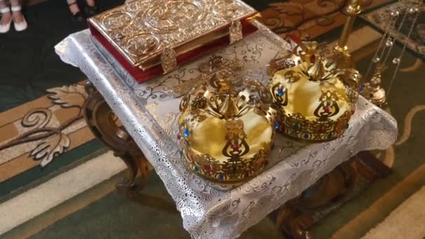 Church attributes for wedding ceremony. Gold crowns are on the altar. Attributes of priest. Interior of church
