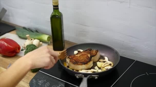 Lahodný steak kladen na rozpáleném grilu zdobený solí a pepřem. Usmažit řízek syrové maso hovězí. maso je smažené máslo a vaření v pánvi. Closeup. Zpomalený pohyb — Stock video