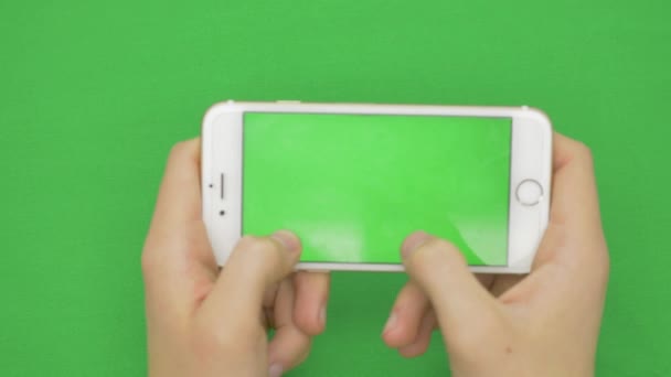 Using smart phone on green screen with various hand gestures, horizontally , close up - green screen — Stock Video