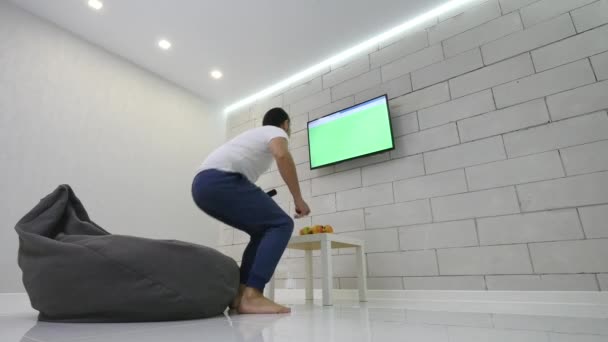 Człowiek ogląda Tv Green Screen w pokoju — Wideo stockowe
