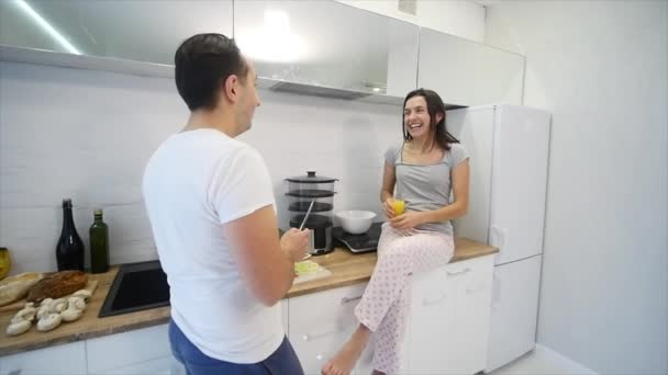 Счастливая пара готовит вместе на кухне. замедленное движение — стоковое видео
