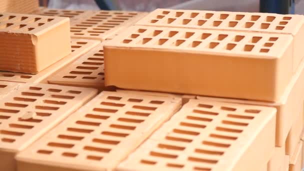Close-up: worker sets the brick at warehouse — Stock Video