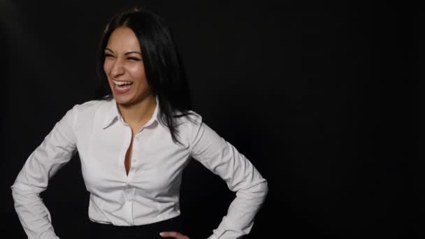 Young successful business woman. Girl on a black background in a white blouse — Stock Video