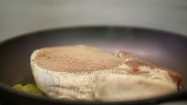 Bife delicioso colocado na grelha quente decorado com sal e pimenta. Bife frito carne crua. a carne que frita a manteiga e aquece-se em uma panela. Fechar. câmara lenta — Vídeo de Stock